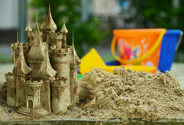 Beautiful sand castle next to sand bucket