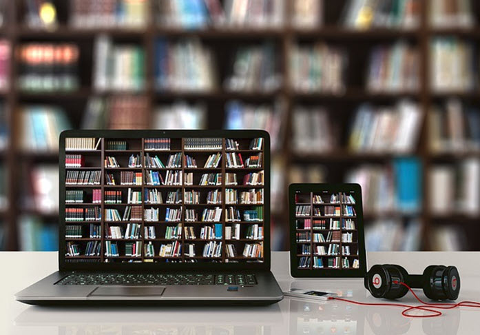 Laptop and Smartphone on table in front of bookshelf